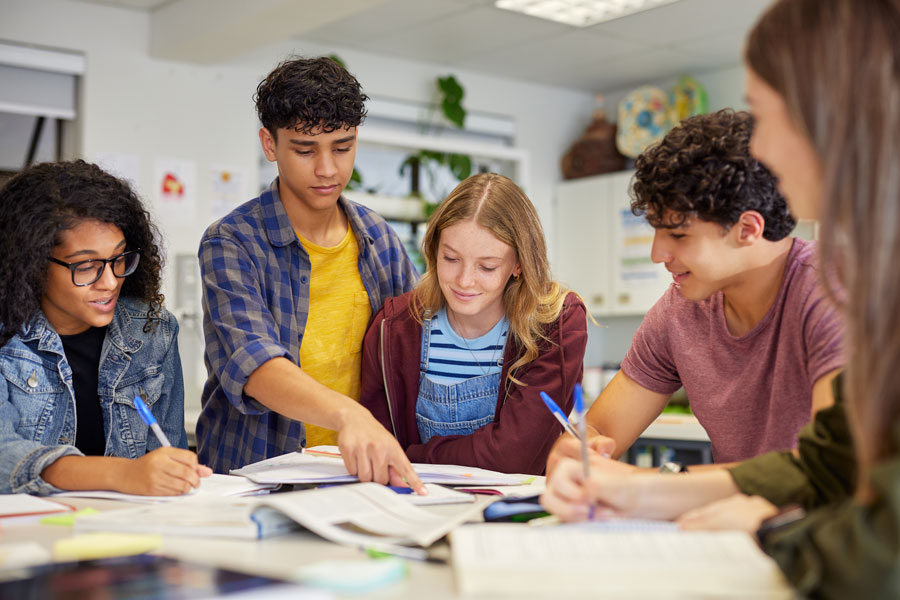Why Does My Teen With ADHD Procrastinate? 1 Teen with ADHD using a planner to organize homework and manage tasks